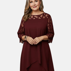Red wine dress with sheer mesh sleeves, geometric cutout yoke, and flowing drape hem