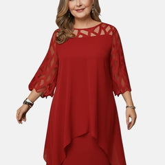 Red dress with sheer mesh sleeves, geometric cutout yoke, and layered asym hem