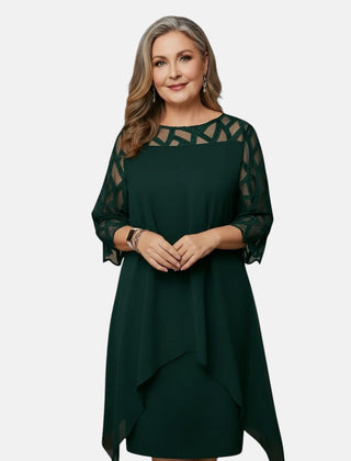 Green dress with sheer patterned sleeves, geometric yoke, and asymmetric draped hem