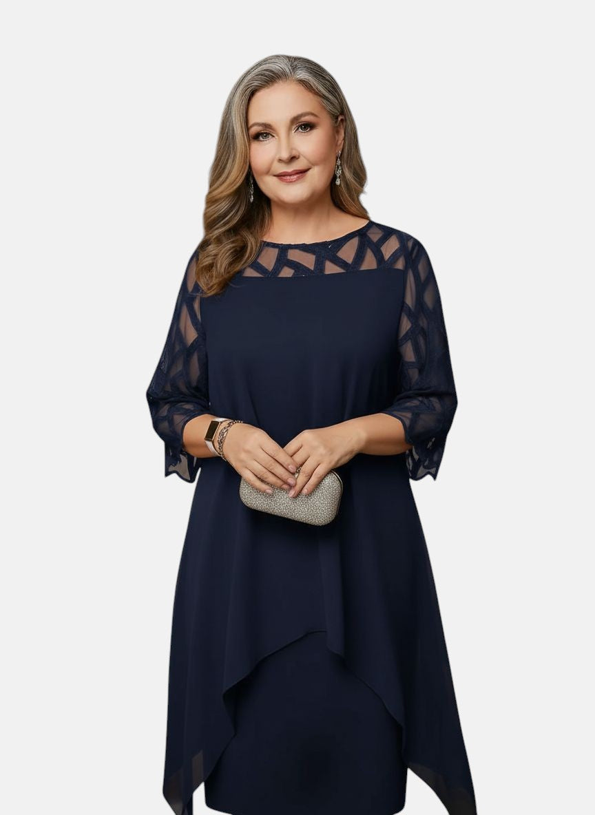 Deep blue dress with sheer patterned sleeves, geometric yoke, and layered asymmetric hem