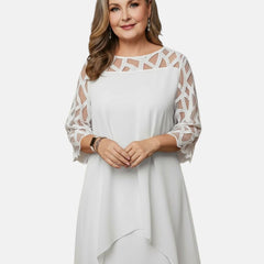 White dress with sheer patterned sleeves, geometric cutout yoke, and draped asymmetric hem