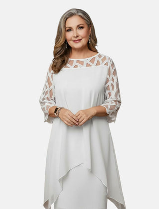 White dress with sheer patterned sleeves, geometric cutout yoke, and draped asymmetric hem