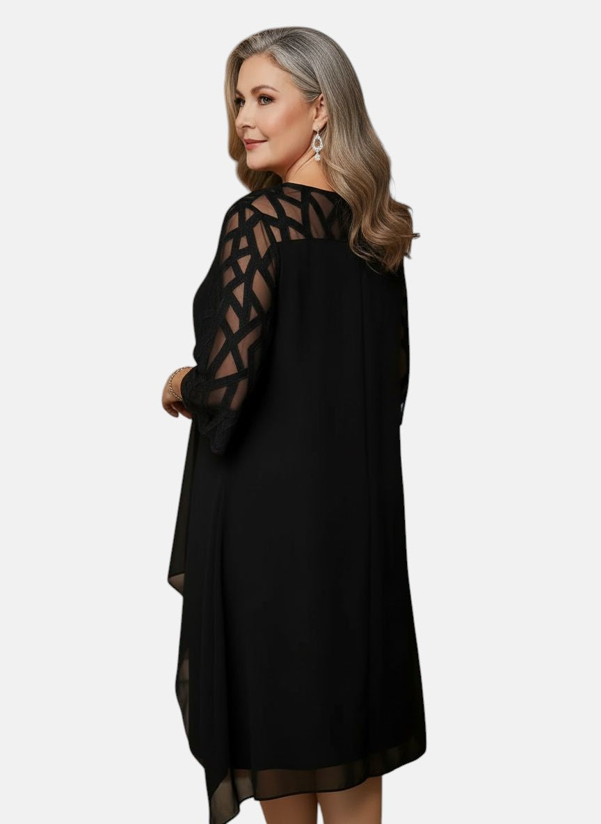 Black dress with mesh sleeves, geometric yoke, and asymmetric drape hem