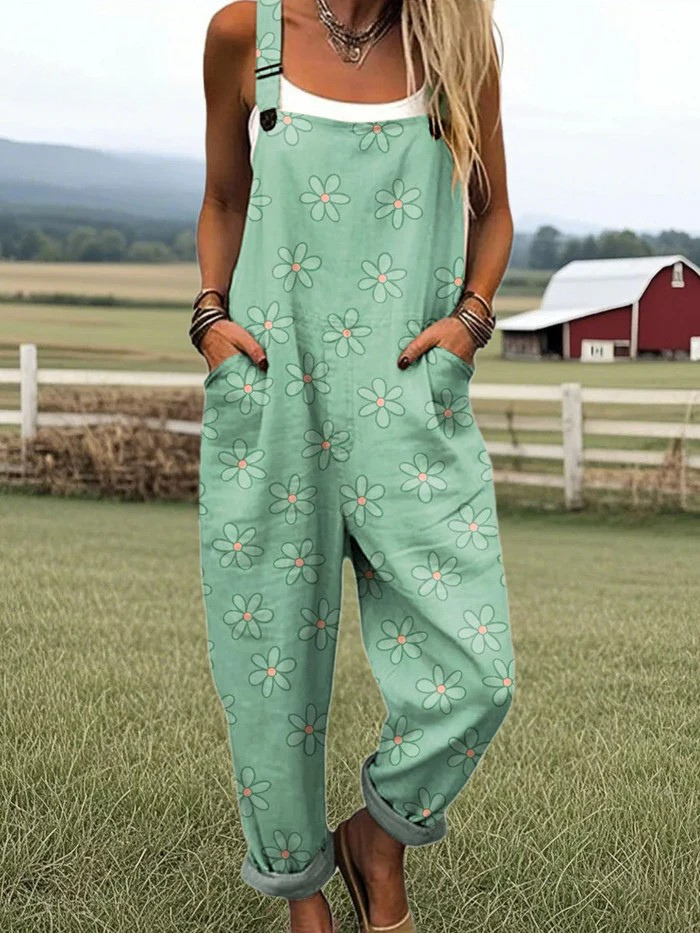 Meadow Muse jumpsuit with mint green floral pattern, adjustable straps, and relaxed baggy legs