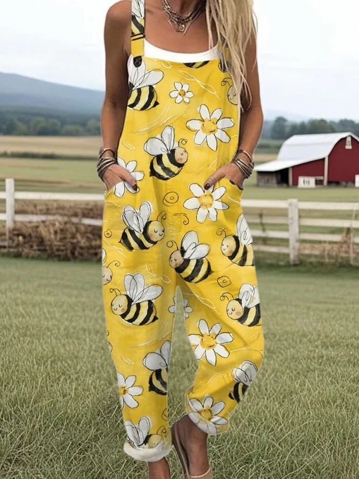 Yellow sleeveless jumpsuit with bee, flower, and cloud print, wide legs