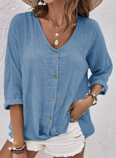 Powder blue V-neck button-front top with loose three-quarter sleeves.