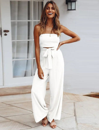 White strapless jumpsuit with tie waist and wide-leg pant legs