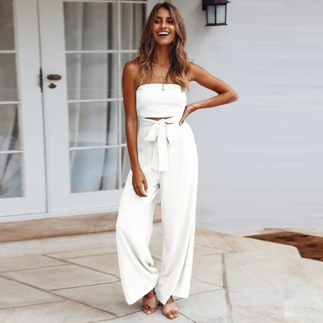 White strapless jumpsuit with tie waist and wide-leg pant legs
