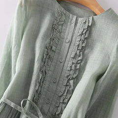 Women’s green button-front dress with ruffled placket and lace-up waist tie