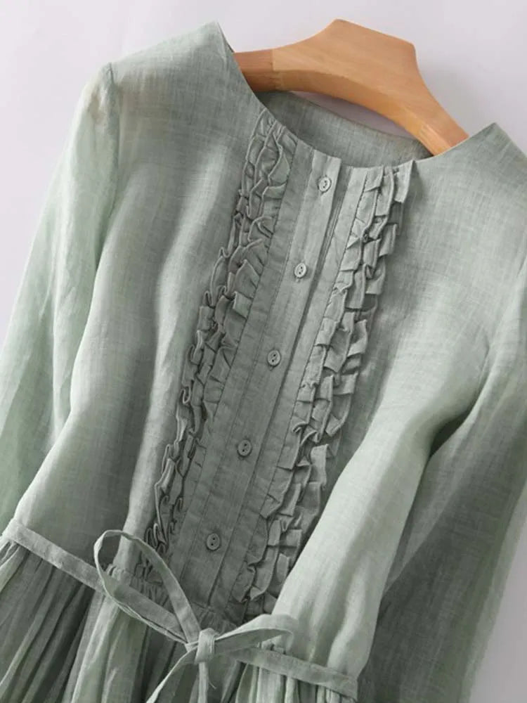 Women’s green button-front dress with ruffled placket and lace-up waist tie