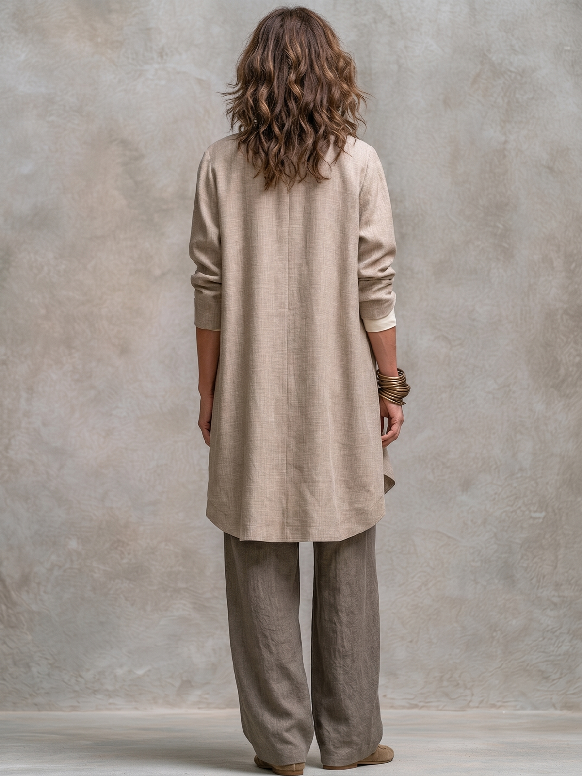 Back view: open beige long cardigan over cream camisole and gray wide-leg palazzo pants