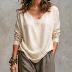 Cream camisole and gray palazzo trousers styled with an open beige cardigan