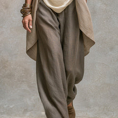 Gray wide-leg palazzo pants with cream camisole and open beige cardigan, side view