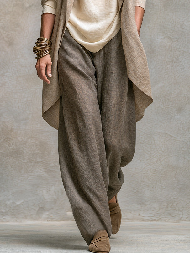 Gray wide-leg palazzo pants with cream camisole and open beige cardigan, side view