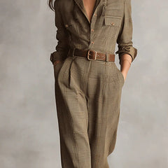 Brown plaid belted jumpsuit with buttoned front, shirt collar, and chest pocket