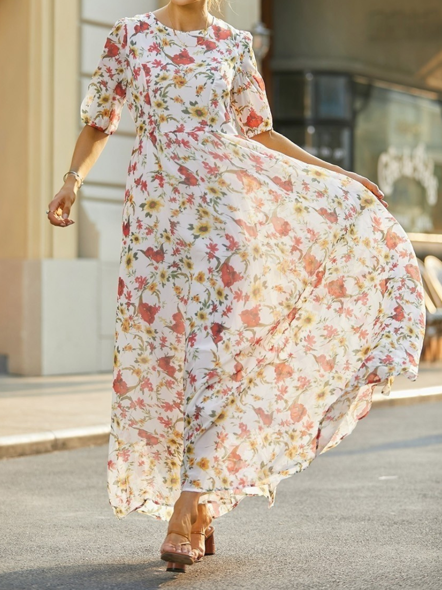 Floral maxi dress with round neckline and short puff sleeves, draped skirt detail