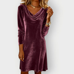 Purple velvet drape-neck shift dress with long sleeves and cowl neckline, knee-length look.