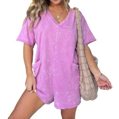 Washed pink short-sleeve V-neck romper with patch pockets and relaxed fit