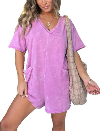 Washed pink short-sleeve V-neck romper with patch pockets and relaxed fit