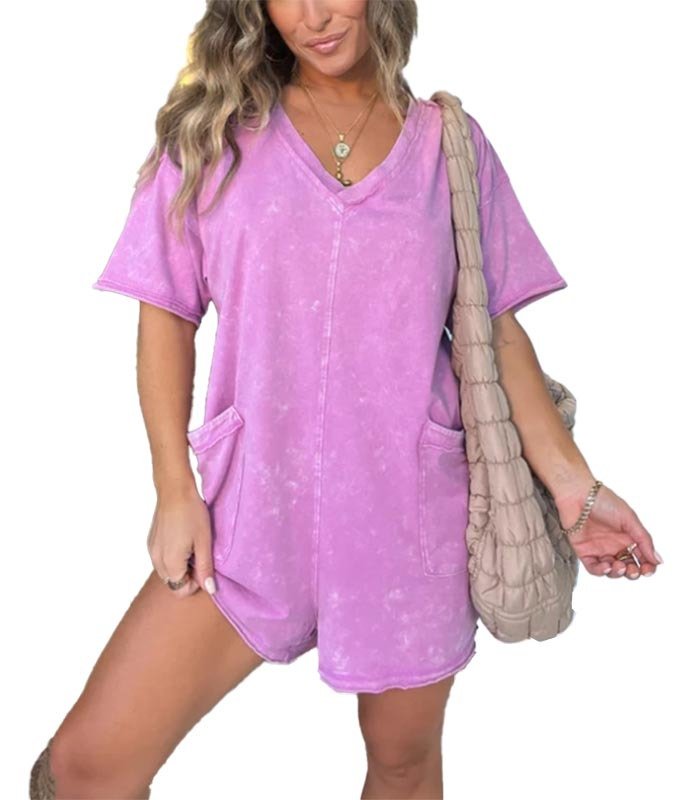 Washed pink short-sleeve V-neck romper with patch pockets and relaxed fit