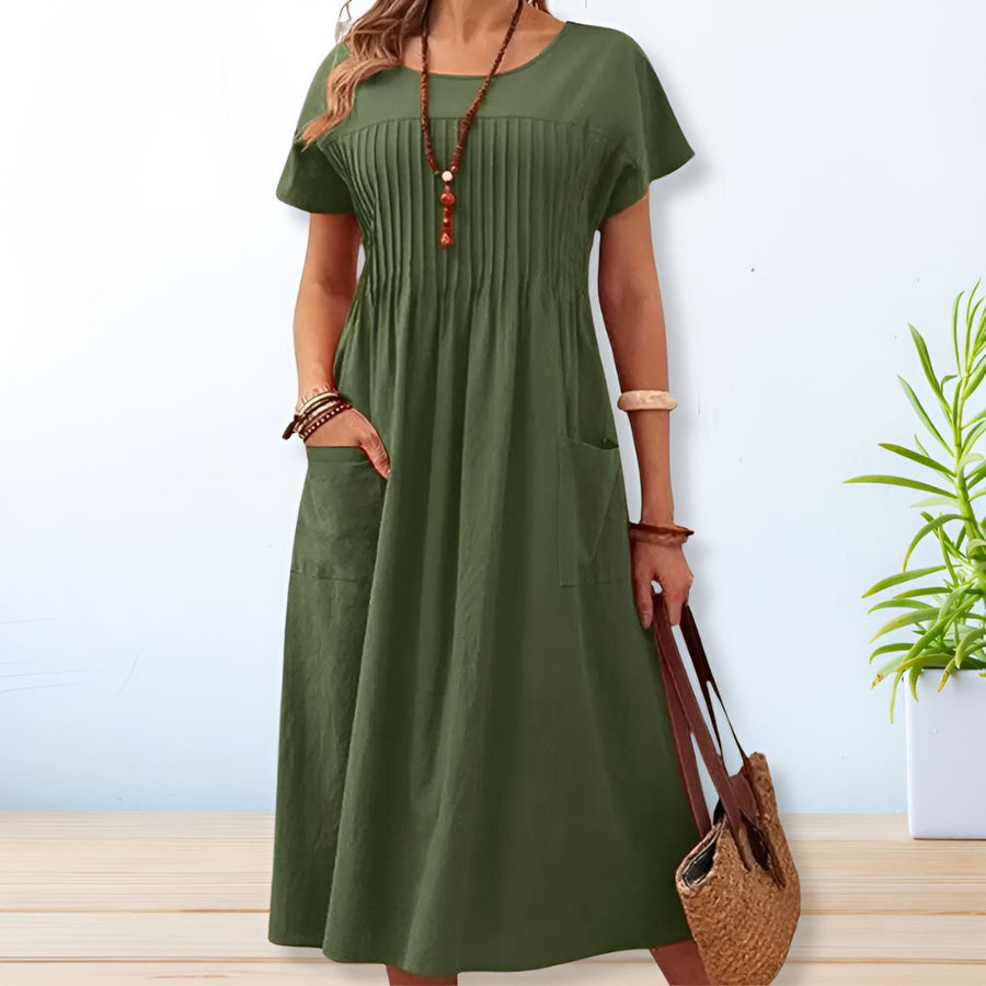 Green short-sleeve dress with scoop neck, gathered bodice and side pockets