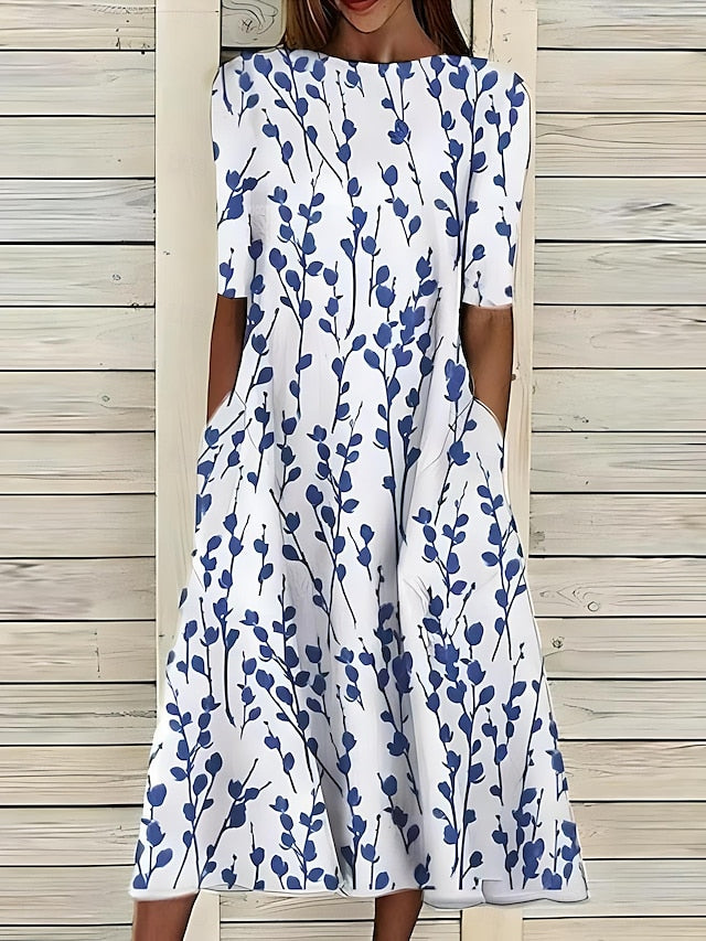 Coastal Bloom dress with white background and blue leaf-stem print, short sleeves