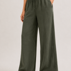 Dark green wide-leg pants with elastic drawstring waist and relaxed legs.