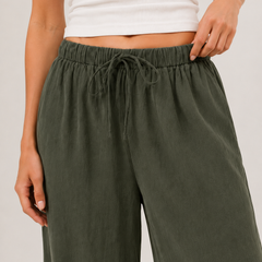 Dark green wide-leg pants with elastic drawstring waist and side pockets.