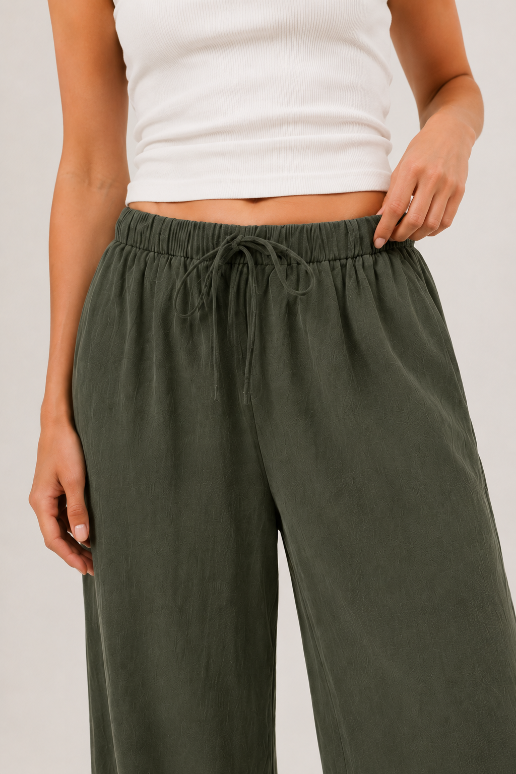 Dark green wide-leg pants with elastic drawstring waist and side pockets.