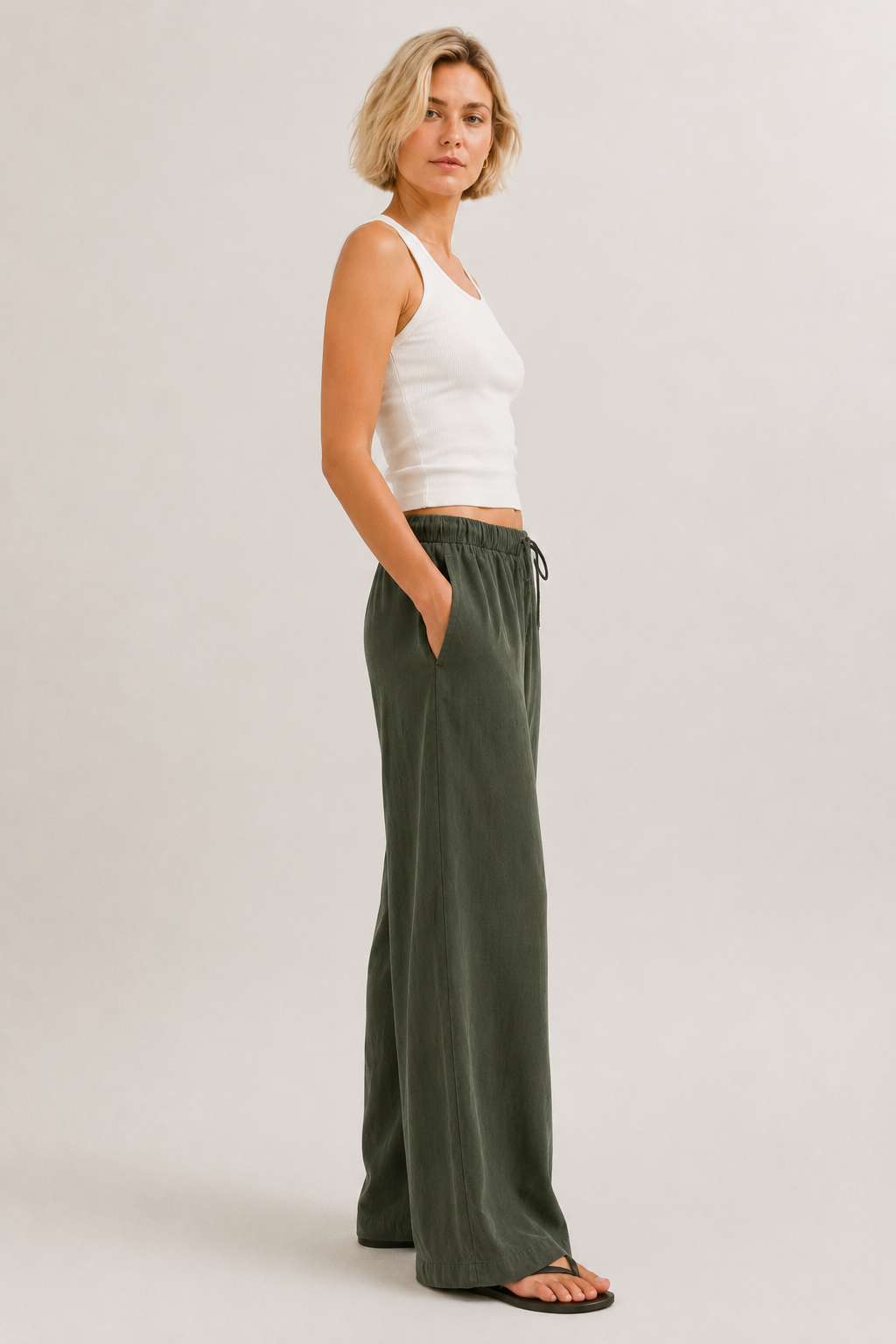 Dark green wide-leg drawstring pants with gathered elastic waist.