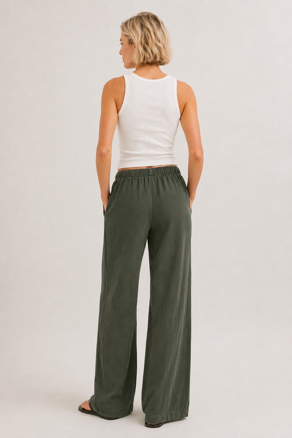 Dark green wide-leg pants with elastic drawstring waist and full-length relaxed fit.