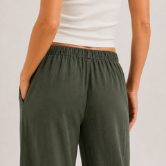Dark green wide-leg drawstring pants with gathered waist and roomy straight legs.
