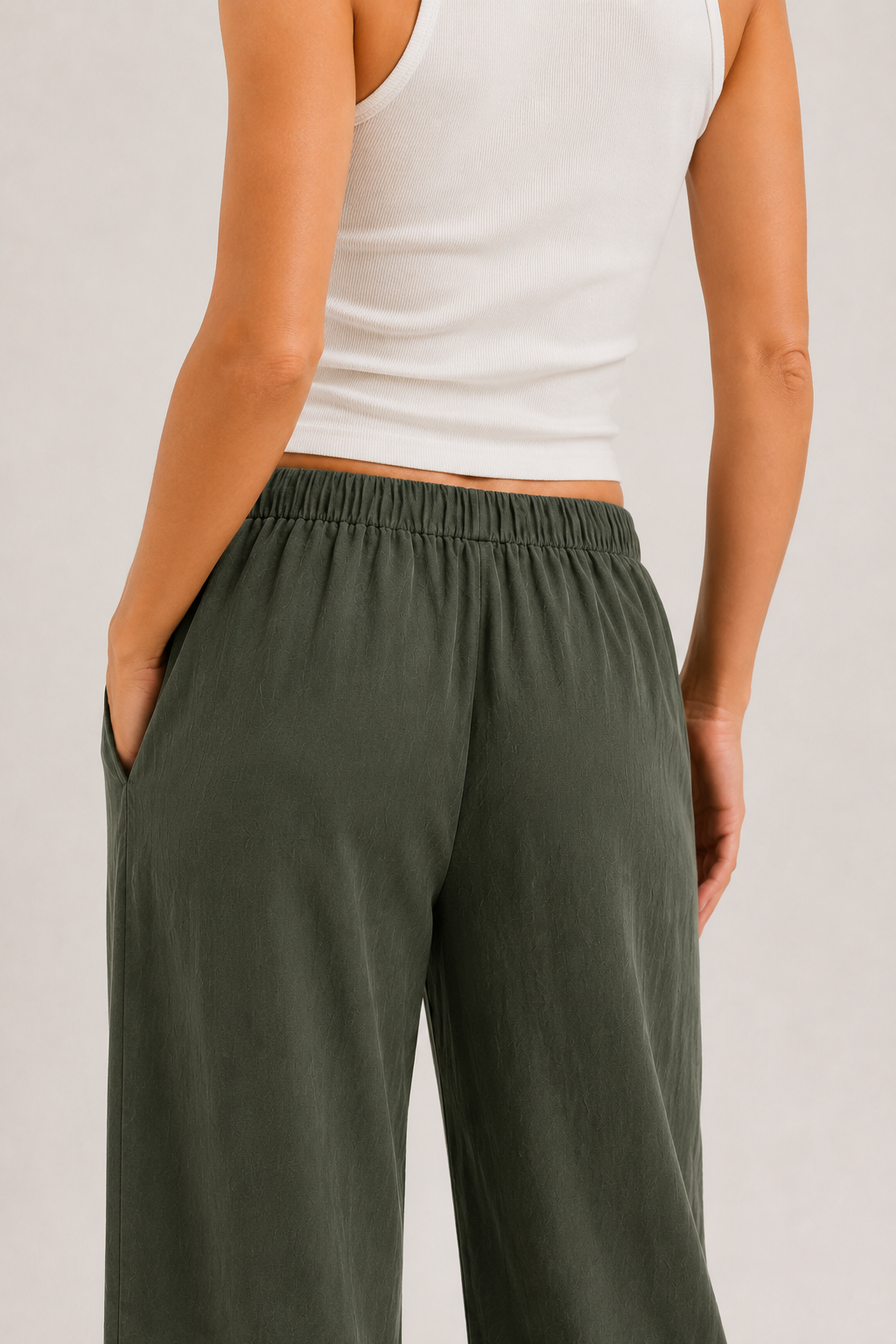 Dark green wide-leg drawstring pants with gathered waist and roomy straight legs.