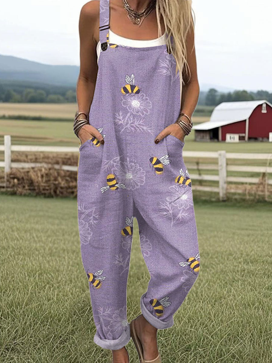 Purple sleeveless jumpsuit with bee-flower print, front pockets and straps