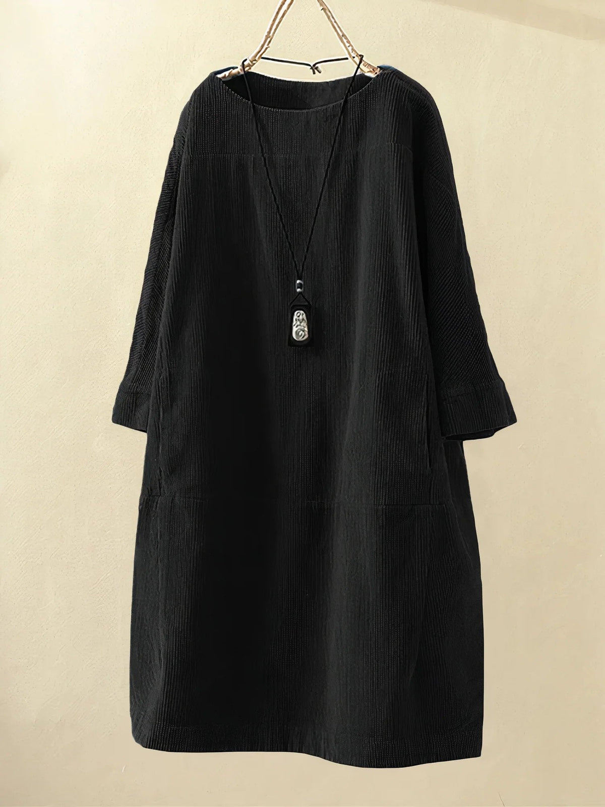 Black corduroy tunic dress with round neckline and 3/4 sleeves