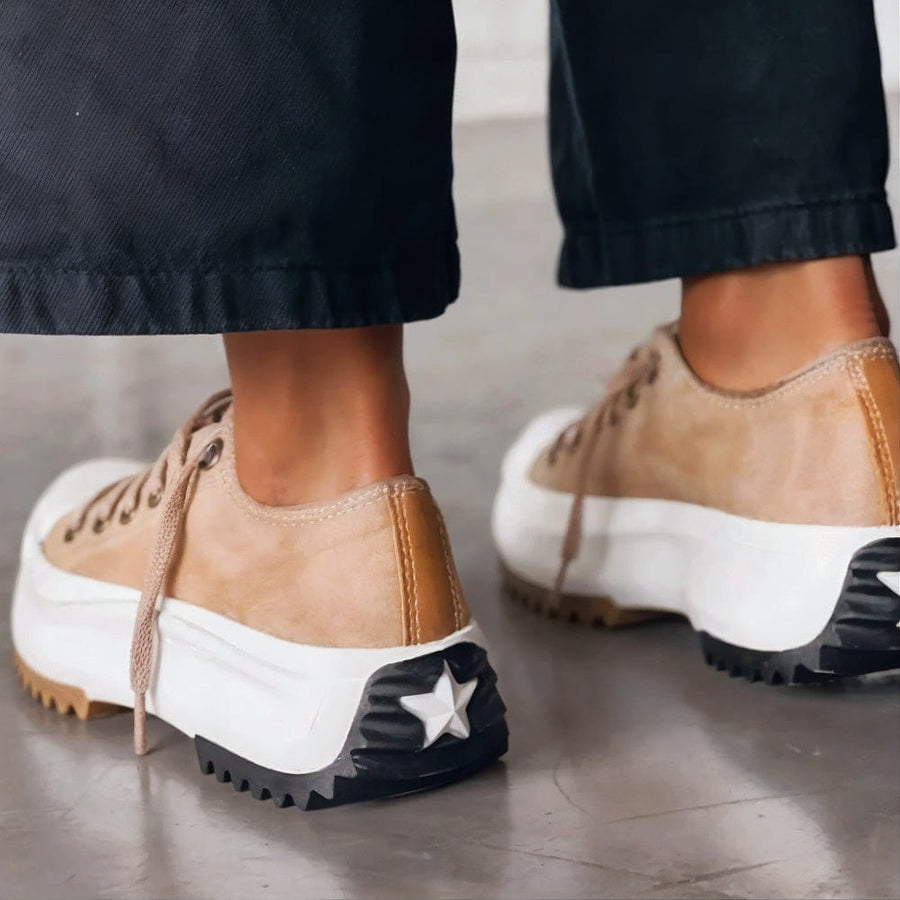 Brown lace-up platform shoes with white sole and star detail at heel