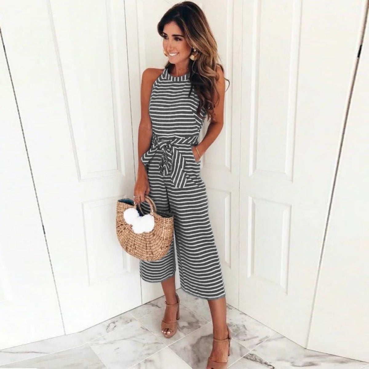 Juna striped jumpsuit in black, sleeveless with round neck and tied waist
