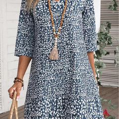 Boho Bloom dress with blue daisy print, three-quarter sleeves, scoop neck, tiered skirt
