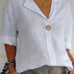 Relaxed white button-up top with V-neck and short sleeves, front button placket.