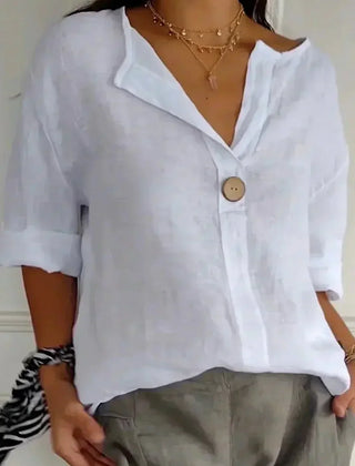 Relaxed white button-up top with V-neck and short sleeves, front button placket.