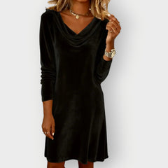 Black velvet drape-neck shift dress with long sleeves and cowl neckline, above-knee length.