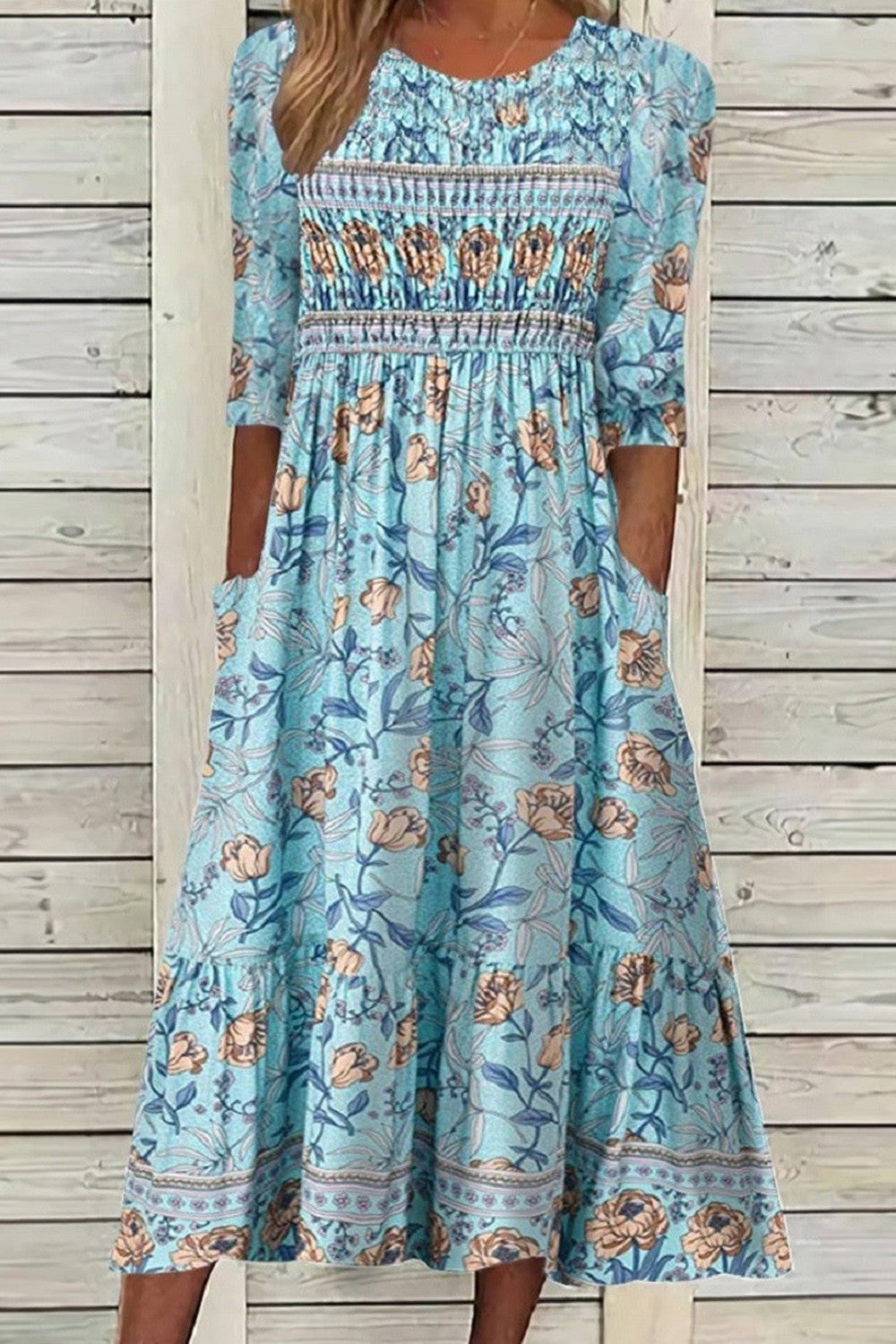 Blue floral tiered midi dress with smocked bodice and three-quarter sleeves
