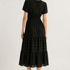 Black tiered midi dress, back view with short sleeves and gathered waist