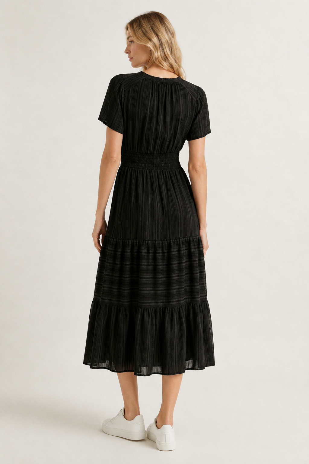 Black tiered midi dress, back view with short sleeves and gathered waist