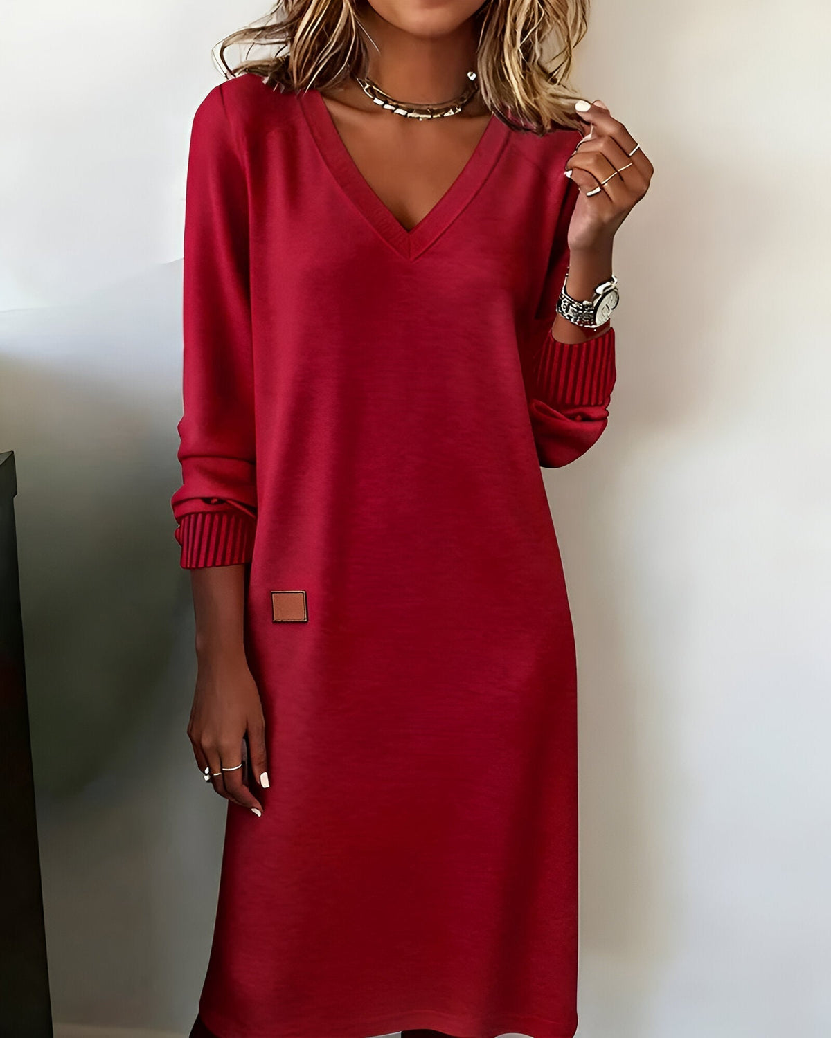 Red V-neck knit midi dress with ribbed striped cuffs and small square side patch