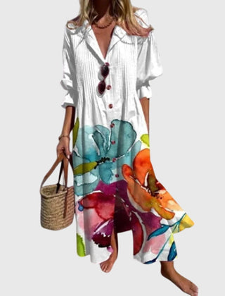White bohemian dress with large colorful floral print, button-front V-neck, short sleeves