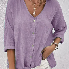 Lavender V-neck button-front top with loose three-quarter sleeves.