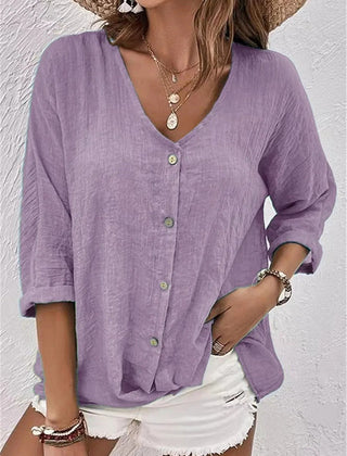 Lavender V-neck button-front top with loose three-quarter sleeves.