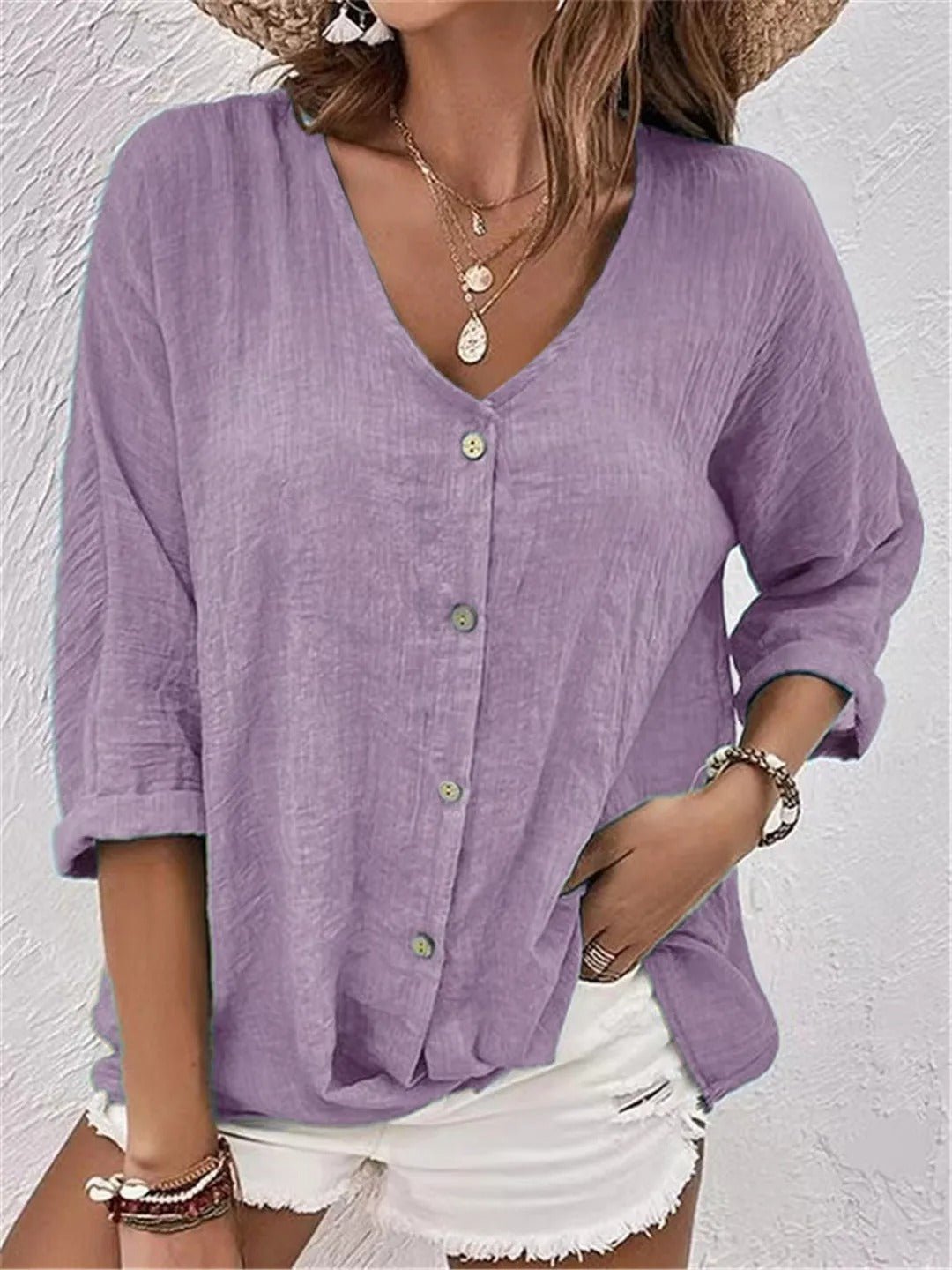 Lavender V-neck button-front top with loose three-quarter sleeves.