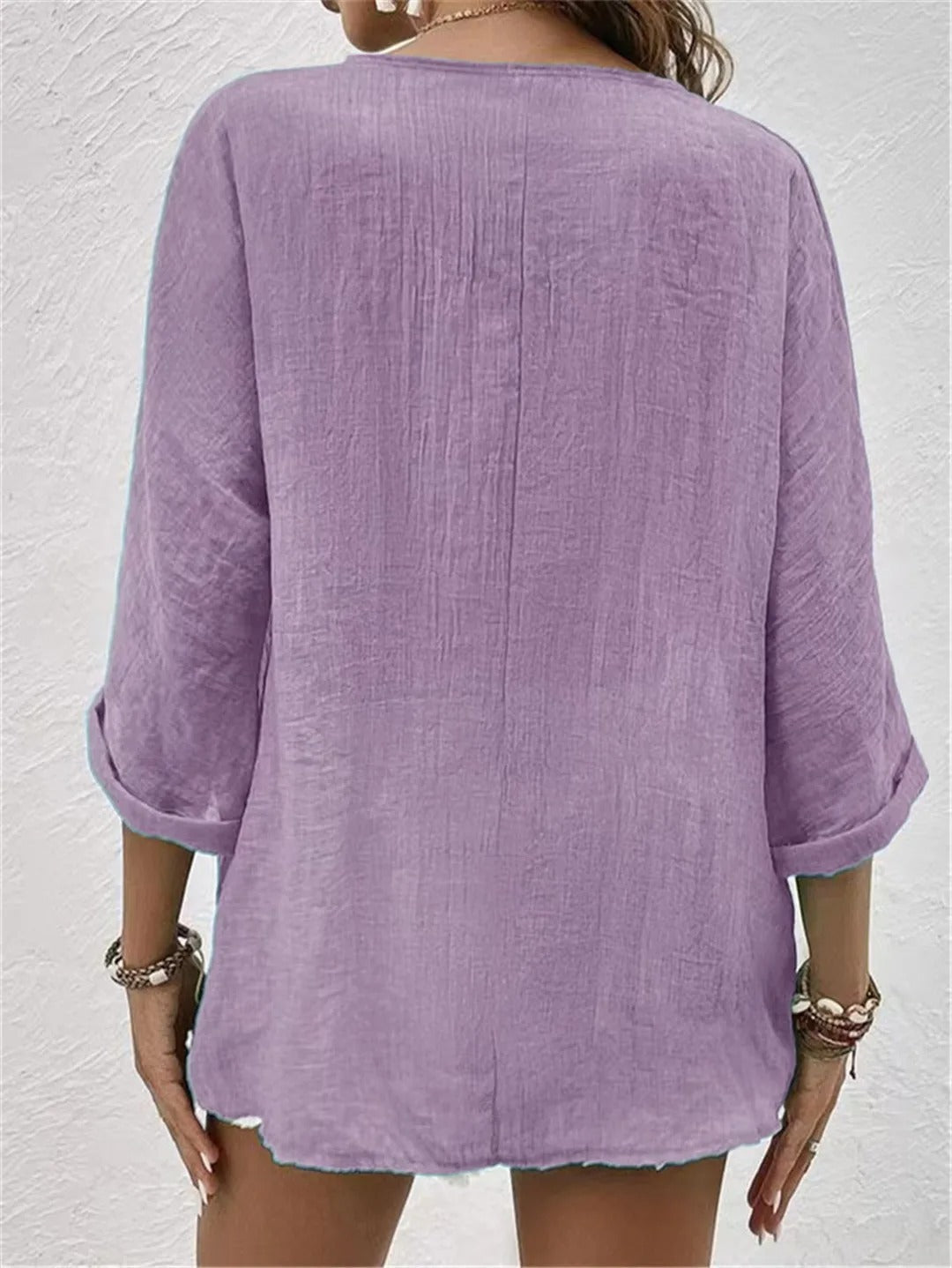 Lavender relaxed top with three-quarter sleeves and a plain back.